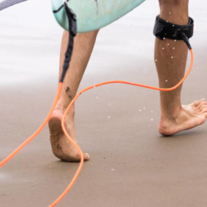 5 Surf Hacks nobody told you before SurfCamp Portugal Algarve Walking surfer legs with leash and surfboard